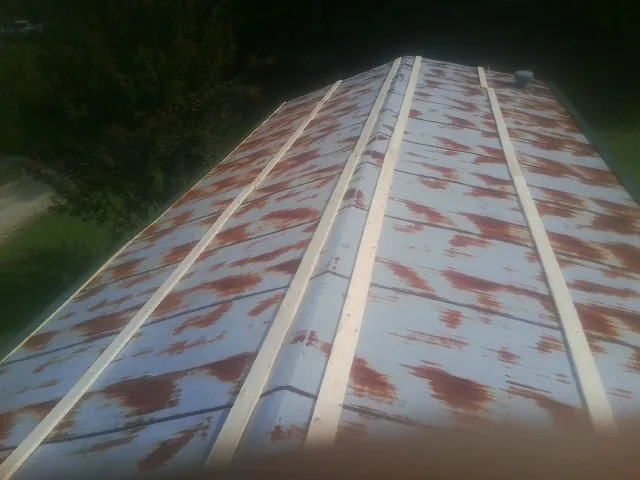Rusted metal roof panels with new wood purlins before replacement — Storm Damage Roof Repair in Rock Falls by Roofing Brothers